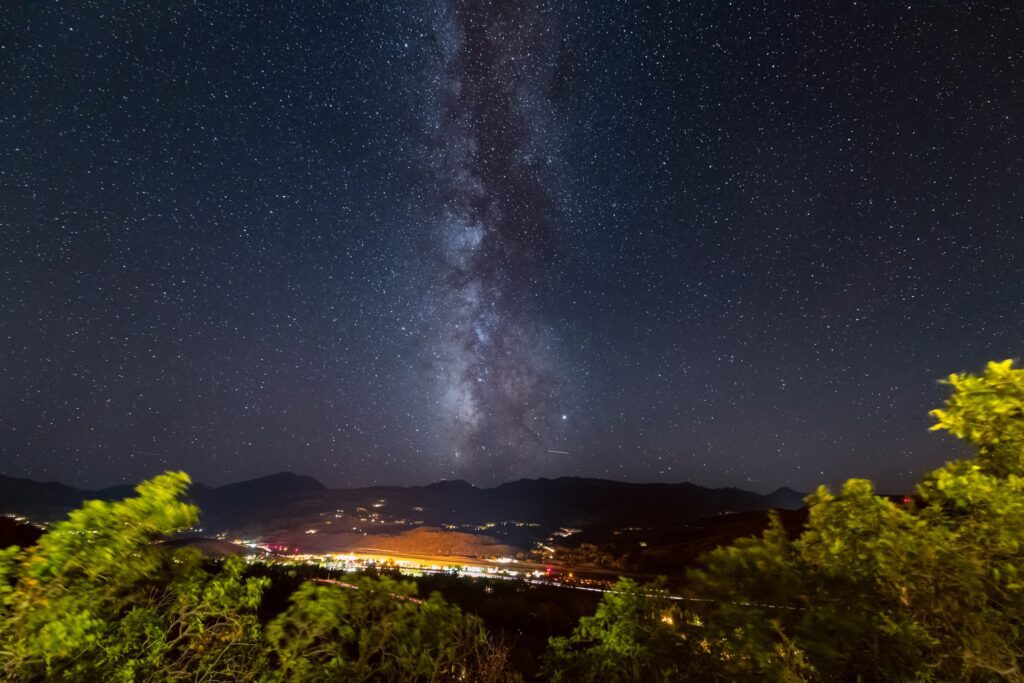 dark starry sky over city lights